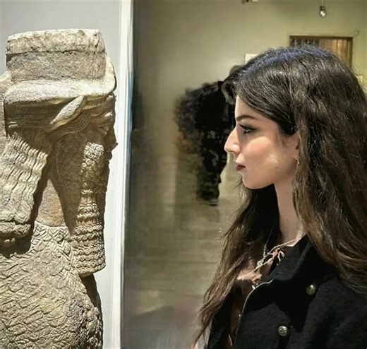 Assyrian Woman Contemplates Ancestral Art | Mesopotamian Heritage