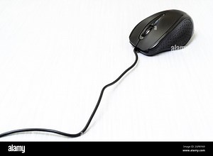 Black computer mouse with cord on white wooden background Stock Photo - Alamy