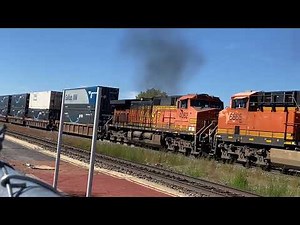 Heavy & powerful train engines pull the long intermodal container railcars