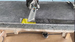 Builder tiler measures the tiles and cuts them with a diamond cutter
