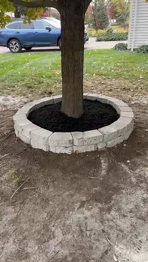 Elevate your yard with paver borders. This tree border was selected to match existing borders around the home. | Escoboza Landscaping LLC