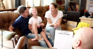 Psychologist helping young family with child to solve problems of child development