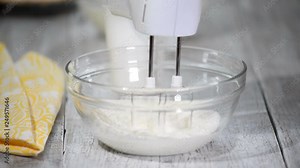 Whipping cream with a hand mixer. Making cream for cake