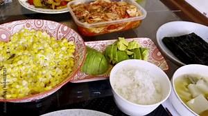 Homemade korean delights: cozy korean cuisine feast with kimchi, soup, nori, white wine, and more in a korean table in the dining room