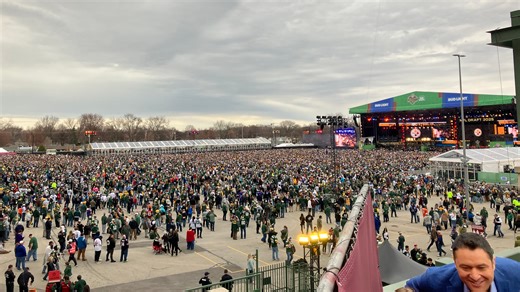 A large NFL Draft crowd chants "Go, Pack, Go!"