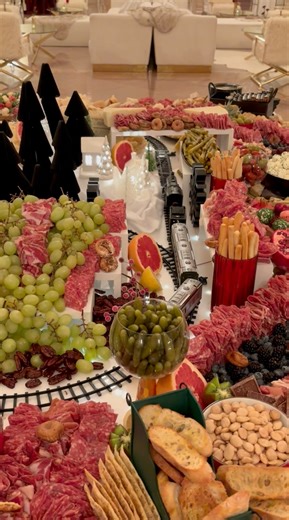 87 reactions | That one time we set up a train set through our signature Charcuterie table at Michigan Central’s holiday party  | Andiamo Catering and Event Management | Facebook