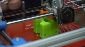 3D printer prints large plastic parts in layers overlaying the filament on each other using FDM printing technology