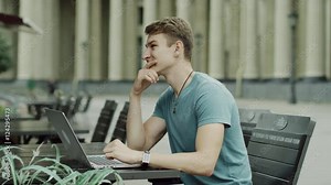 man closes a laptop