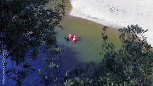 Tourists canoeing under the Pont d'Arc on the Ardèche river near Vallon-Pont-d'Arc in the south of France