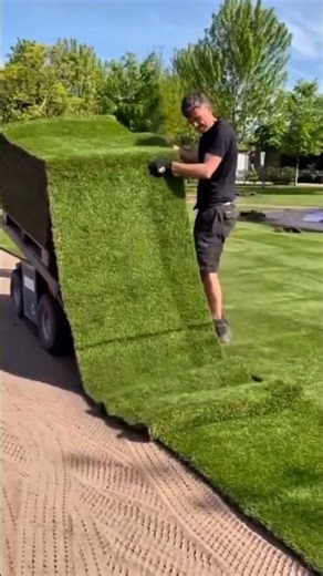 This man installs synthetic grass using a special machine making the process faster neater #machine
