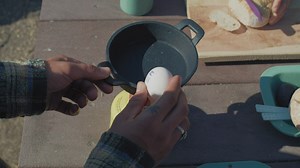 Cooking breakfast at a campsite - Free Stock Video