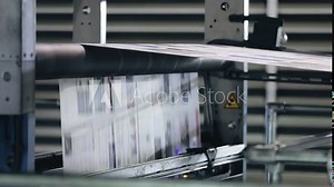 The printing process of a weekly magazine with facilities of a copier shop. Close-up shot of newspaper production on a conveyor belt. High quality FullHD footage