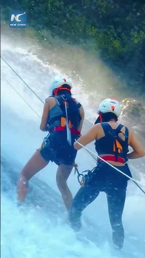 Waterfall rappelling in China's Guizhou