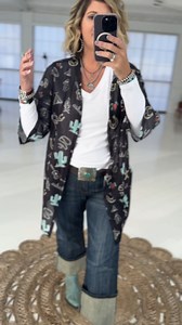 The Black Sky Duster is a fun western print duster made of a stretchy mesh fabric. This one can be worn now with a long sleeve and worn in spring and summer with shorts or a tank! So versitile! It comes in one size and one size plus. Get the details here ---> Super stretchy and forgiving western print mesh fabric duster | Rolling Ranch Boutique