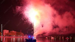 Fireworks grand finale seen across a river 4K