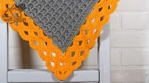 What colors would you use for this blanket? The waffle stitch is beautiful and looks even better surrounded by this arcade border. | Winding Road Crochet