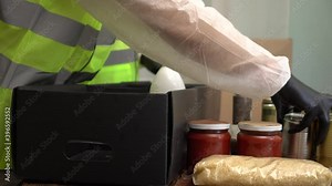 Volunteers put items in baskets. Food, meals, gifts, and other assistance is offered to struggling families, seniors, and children. Donation, charity, feeding