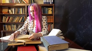 the girl with the pink hair in the library reading books