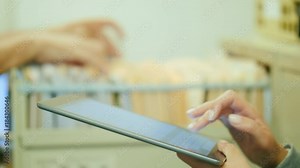 Old archive and new technologies. Workers in the office are sorting documents into an old document storehouse with drawers