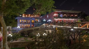 Illuminated Bridge of Sighs night timelapse hyperlapse. Tourists and locals crossing the Bridge of Sighs in the Barranco district of Lima Peru.