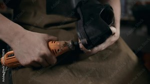 shoemaker makes shoes for men He polishes sole of shoe handmade craft production factory leather boots