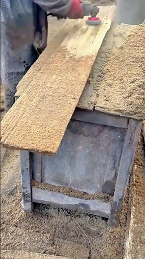 smoothing a long rough wooden board using an electric power planer to remove sawdust