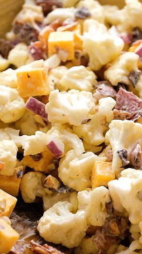 This loaded Cauliflower Salad recipe is the perfect summertime dish made with fresh cauliflower, cheddar cheese, bacon bits, salted almonds, red onion, and creamy mayo. | The Best Keto and Low Carb Recipes