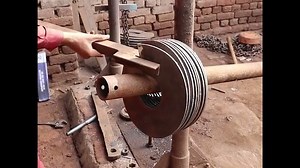 Workers making a screw conveyor