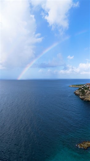 Blue Bay Curacao on Instagram: "POV: you’re at Blue Bay and the sky says “welcome.” 🌈 Beach breeze, soft waves, and that rainbow glow. See you soon!"