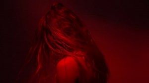 Blond lady dancing in red light