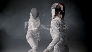 Fencing training - two young woman having a duel between each other