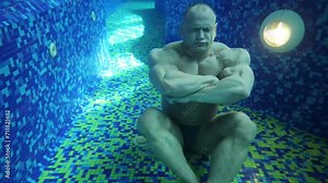 Athlete falls on bottom of pool with tiles and strains muscles