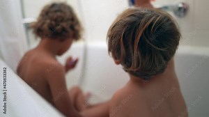 Two little brothers taking bath together