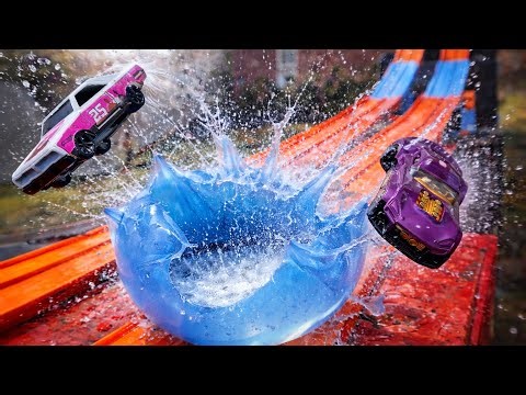 Car Ramp Stunt Into a Giant Water Balloon