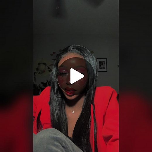 Person with Black Hair in Red Jacket Sitting Indoors