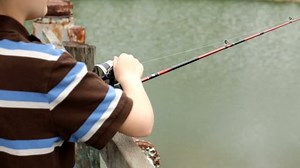 clip-6206075-young-boy-fishing-off-dock