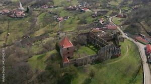 Aerial footage of a medieval fortication ruin shot from a drone while circling around the keep. Video of a medieval keep on top of the hill.