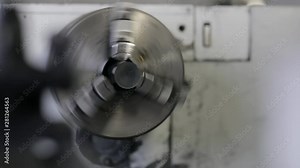 Machining and shaping carbon fibre on lathe with hands, slow motion