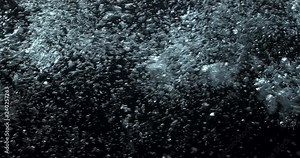 4K underwater illuminated bubbles motion. Ocean floor bubbles. Real underwater footage. Deep under sea level. Floating plankton. Marine background VFX element. Underwater bubbles mayhem