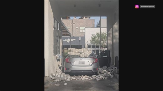 Wind causes a brick wall to fall onto a car in a Starbucks drive-thru