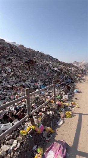 The other side of Gaza; streets are overflowing with garbage, piling up daily as resources to clear them are scarce. Among the trash lie missile fragments and shells, remnants of ongoing Israeli bombardment that still threaten lives of Palestinians, especially children. Families live under the weight of both destruction and neglect, struggling to survive amid a city silently drowning in pain. | Our Palestine Anonymous
