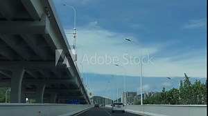 low angle view of Yantai's city interchange, with intersecting roads, from a vehicle perspective, China