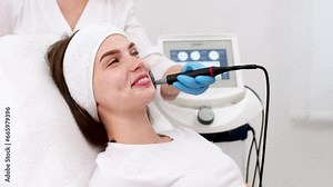 Close-up of a young woman's face during microcurrent therapy. Procedure for electrical stimulation of the face, rejuvenation, anti-wrinkle. The concept of youth and modern cosmetology technologies. Stock Video