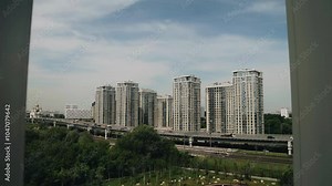 Outside the window you can see a busy highway in a big city. The camera gradually approaches the window. urban atmosphere in the frame