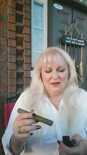 woman shows how to light a cigar properly