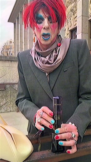 Performance artiste David Hoyle refills a Mugler fragrance
