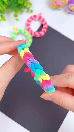 23K views · 36 reactions | Title: DIY Braided Hair Tie Bracelet Hashtags: #BraidedBraceletDIY #HairTieCraft #DIYWristBand #EasyBraceletMaking #BraidedAccessory #UpcycledJewelry #CraftyBracelet #DIYFashion #HandmadeBracelet #CreativeWristwear | paper craft | Facebook