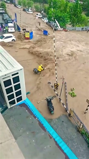 Powerful Floodwaters Rush Through Streets in China 🌊⚠️ #Shorts