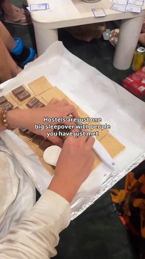 2.7K views · 4 comments | Making s’mores and playing games  Hostels are the secret social hack for travelers. They’re more than just a bed for the night. They’re lively spaces where backpackers, remote workers, and thrill seekers cross paths. Picture shared rooms, open kitchens, and rooftop hangouts where total strangers turn into your next travel crew. #howzithostels #hawaii #hostellife #solotravel #budgettravel #hawaiitravel #hostel | Howzit Hostels | Facebook