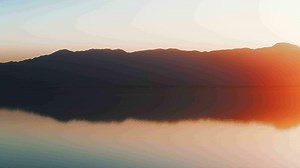 Aerial view of sunset horizon over the sea. Cinematic drone aerial view beautiful evening sunset in sky over the sea. Sun path is reflected in sea surface. Nature beauty.